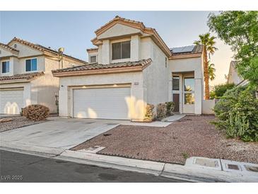 Charming two-story home featuring a two-car garage, desert landscaping, and a warm, inviting entrance at 3525 Tuscany Village Dr, Las Vegas, NV 89129