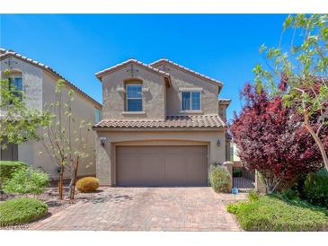 Charming two-story home with a paved driveway, desert landscaping, and a tile roof at 358 Badinerie St, Henderson, NV 89011