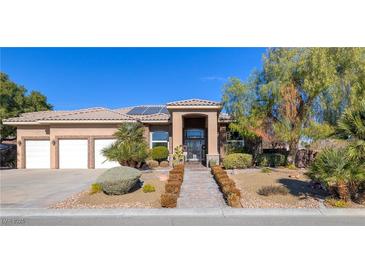 Stunning single-story home features a tile roof, desert landscaping, and an iron gate entrance at 5193 N Miller Ln, Las Vegas, NV 89149
