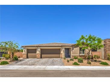 Charming single-story home with a three-car garage, desert landscaping and stone accents at 6280 Lamont Hills Ave, Las Vegas, NV 89139