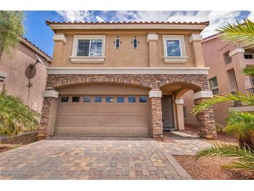 Charming two-story home showcasing a stone-accented facade and a neatly paved driveway at 8222 Sorrel St, Las Vegas, NV 89139