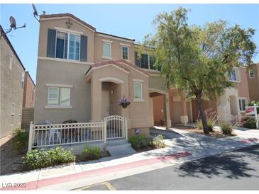Inviting townhome with a charming front porch and well-maintained landscaping at 10360 Lettuce Leaf St, Las Vegas, NV 89183