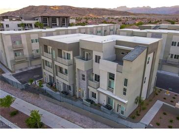 Modern townhome exterior featuring clean lines, neutral tones, and private balconies with mountain views at 1163 Blossom Point St, Las Vegas, NV 89135