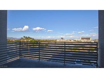 Enjoy the stunning city view from this private balcony with horizontal metal railings at 1187 Blossom Point St # 36, Las Vegas, NV 89135