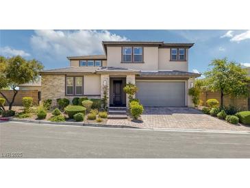 Beautiful two-story home featuring a neutral palette, manicured landscaping, and a paved driveway at 12311 Middle Creek St, Las Vegas, NV 89138