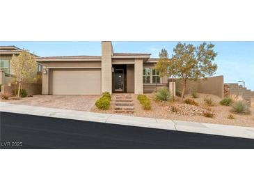 Charming single-story home featuring a well-manicured front yard, desert landscaping, and an attached two-car garage at 12550 Point Sierra St, Las Vegas, NV 89138