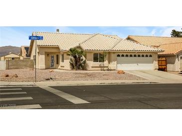Charming single-story home featuring a xeriscaped yard, tile roof, and attached two-car garage at 3214 W Gilmore Ave, North Las Vegas, NV 89032