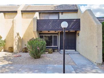 Inviting townhome exterior features a well-maintained facade and xeriscaped front yard at 3233 Kinsale Ct, Las Vegas, NV 89121