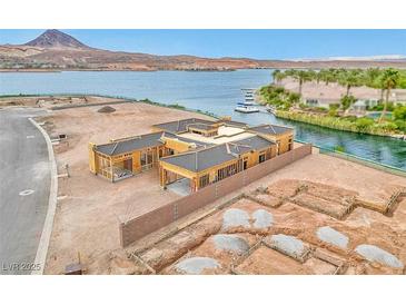 New construction home framing with lake view, showcasing modern design and luxurious waterfront living at 54 Bellissima Lago Ct, Henderson, NV 89011