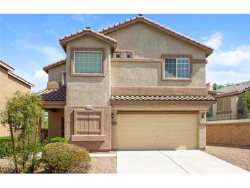 Two-story home with neutral stucco, tile roof, manicured landscaping and two-car garage at 5676 Bettors Luck Ct, Las Vegas, NV 89122