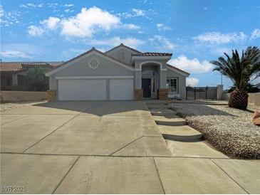 Charming single-story home featuring a well-manicured yard and a spacious three-car garage, complete with a tile roof at 676 Covina Dr, Henderson, NV 89002