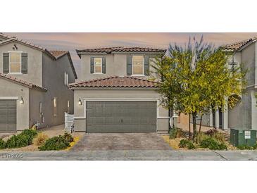 Charming two-story home featuring a well-maintained front yard and a two-car garage at 6848 Calvitero St, Las Vegas, NV 89149