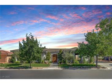 Charming single story home boasts a beautiful landscaped front yard and a covered entry at 10969 Tranquil Waters Ct, Las Vegas, NV 89135