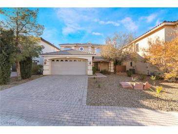 Beautiful two-story home featuring a front yard, a two-car garage, and a brick driveway at 10993 Ladyburn Ct, Las Vegas, NV 89141