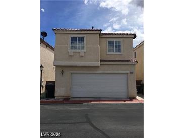 Two-story home featuring a two-car garage, neutral stucco, and a red tile roof at 3123 Inlet Bay Ave, North Las Vegas, NV 89031