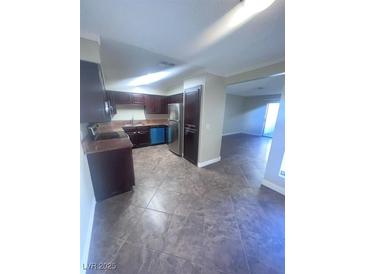 Well-lit kitchen featuring stainless steel appliances and tiled flooring at 3151 Soaring Gulls Dr # 1092, Las Vegas, NV 89128