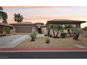 Charming single-story home featuring a three-car garage, desert landscaping, and a cozy front entrance at 3904 Redbreast Ln, North Las Vegas, NV 89084
