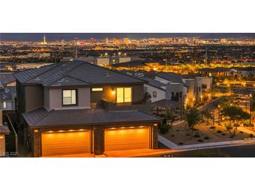 Spectacular home showcasing illuminated city views, balcony, and two-car garage at 460 Pear Lake St, Las Vegas, NV 89138