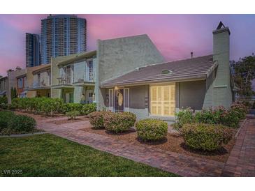 Charming single-Gathering home with brick walkway and manicured landscaping at 590 Tam O Shanter, Las Vegas, NV 89109