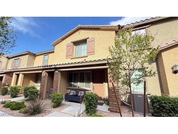 Charming two-story townhome with covered porch and cozy front patio seating area at 6247 Milford Sound St, Las Vegas, NV 89148