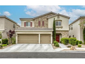 Charming two-story home featuring a stone facade, three-car garage, and well-manicured landscaping at 8137 Crushed Velvet Pl, Las Vegas, NV 89166