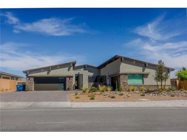 Beautiful single-story home featuring a modern design, desert landscaping, and a two-car garage at 8310 W Camero Ave, Las Vegas, NV 89113