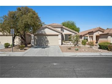 Single-story home with desert landscaping, a two-car garage, and a tile roof at 11079 Zampino St, Las Vegas, NV 89141