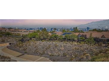 A Las Vegas home showcasing stunning city skyline views and desert landscaping at 2167 Shadow Canyon Dr, Henderson, NV 89044