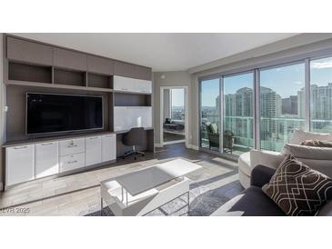 Modern living room features built-in storage, sleek furniture, and sliding glass doors to a balcony at 222 Karen Ave # 3104, Las Vegas, NV 89109