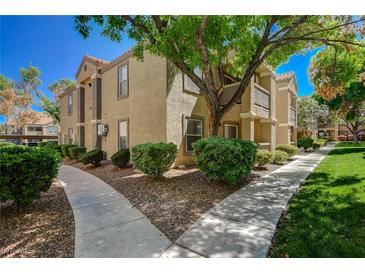 Inviting condo exterior with well-maintained landscaping and neutral color palette at 2300 E Silverado Ranch Blvd # 1123, Las Vegas, NV 89183