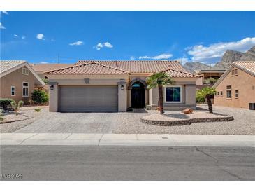 Charming single-story home with a tile roof, desert landscaping, and an attached two-car garage at 2305 Hot Oak Ridge St, Las Vegas, NV 89134