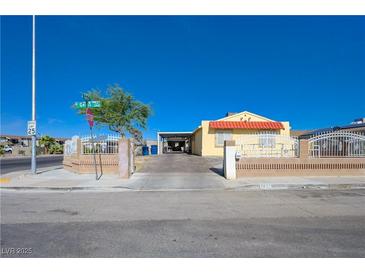 Charming single-story home featuring a well-manicured front yard and a welcoming front entrance at 2832 Geist Cir, Las Vegas, NV 89115