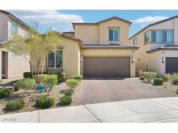Charming two-story home with a two-car garage, brick driveway, and desert landscaping at 2877 Sweeping Palm Rd, North Las Vegas, NV 89086