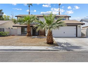 Charming two-story home with mature palm trees and a well-maintained yard at 5035 Meadow Grove Ct, Las Vegas, NV 89120