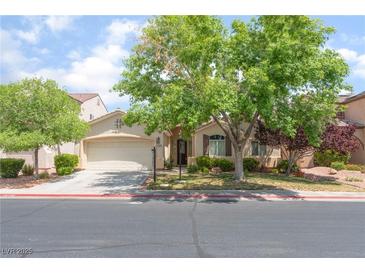 Charming single-story home with a two-car garage and mature landscaping on a sunny day at 5844 Gushing Spring Ave, Las Vegas, NV 89131