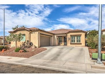 Charming single-story home with a well-maintained front yard and a spacious driveway on a sunny day at 6329 Sterling Ranch Way, North Las Vegas, NV 89081