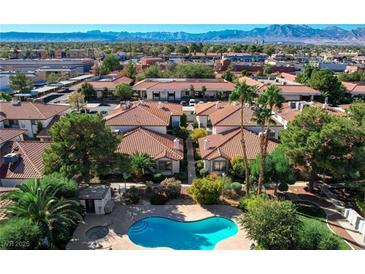 Aerial view of the neighborhood pool and hot tub surrounded by well-maintained landscaping and homes at 6733 W Charleston Blvd # 3, Las Vegas, NV 89146