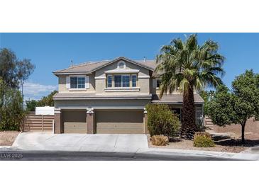Charming two-story home with a three-car garage and a well-manicured front yard with mature trees at 7360 Dolphine Crest Ave, Las Vegas, NV 89129