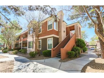 Charming multi-story condo with colorful facade and inviting entrance staircase at 7704 Himalayas Ave # 204, Las Vegas, NV 89128