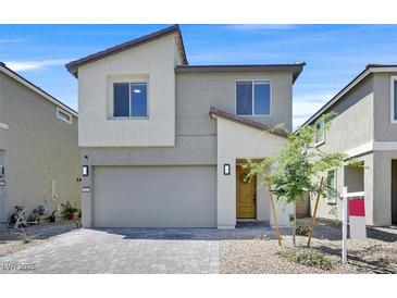 Charming two-story home featuring a modern design, two-car garage and desert landscaping at 8043 Texas Hills St, Las Vegas, NV 89113