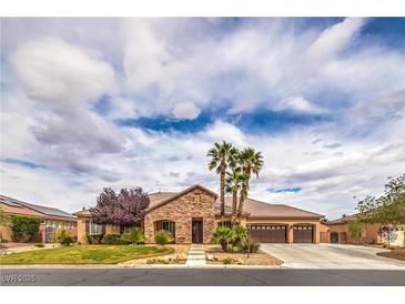Charming single-story home featuring desert landscaping, a three-car garage, and a stone facade at 8216 Tursi Lodge Ct, Las Vegas, NV 89131