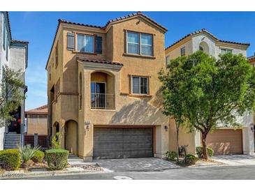 Beautiful two-story home featuring a balcony, attached two car garage and manicured landscaping at 9526 Summer Furnace St, Las Vegas, NV 89178