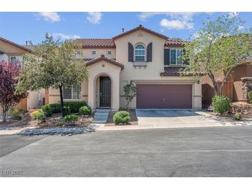 Charming two-story home featuring a two-car garage and landscaped front yard at 10135 Haymarket Peak Ave, Las Vegas, NV 89166