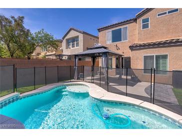 Enjoy this refreshing pool featuring a safety fence and a gazebo, perfect for outdoor relaxation at 10241 Headrick Dr, Las Vegas, NV 89166