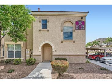 Apartment exterior shows stucco facade, arched entry, and manicured landscaping at 10550 W Alexander Rd # 2179, Las Vegas, NV 89129