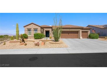 Charming single story home featuring desert landscaping, a three car garage, and a tile roof at 2962 Gettysburg Ave, Henderson, NV 89052
