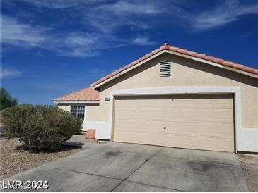 Exterior shot featuring a two car garage and blue skies at 3012 Silver Canyon Ln, North Las Vegas, NV 89031