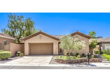 Charming single-story home featuring a well-maintained front yard and a two-car garage at 35 Glade Water Dr, Henderson, NV 89052