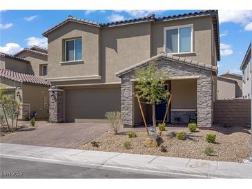 Charming two-story home with a stone-accented front porch and well-maintained landscaping at 4436 Mural Glen Ct, North Las Vegas, NV 89084