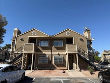 Exterior view of an attractive multi-unit home featuring a light brown facade and ample parking at 4670 Tracylynn Ln, Las Vegas, NV 89121